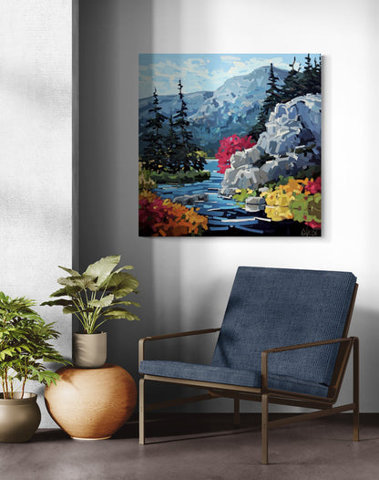 tableau coloré dans un décor épuré.  le tableau est placé au dessus d'un fauteuil contemporain de couleur bleu-gris s'agençant à la peinture. La scène est agrémentée de quelques pots de fleurs en grès.
